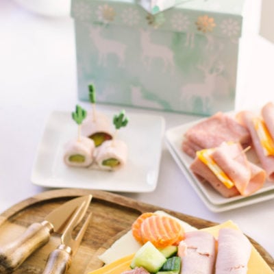 Meats and cheeses on a board and plates