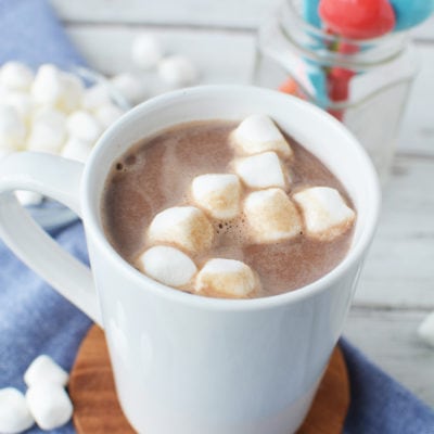 Mug of hot cocoa topped with marshmallows on a table