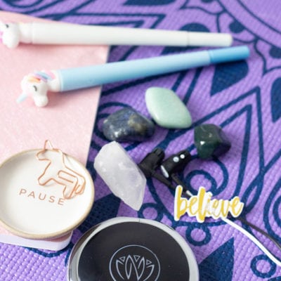 Unicorn pens, stones, and Zen unit on a yoga mat