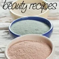 Composition of ceramic bowls with different types of sea clay powder: white, pink, green and blue; concept of facial and body treatment