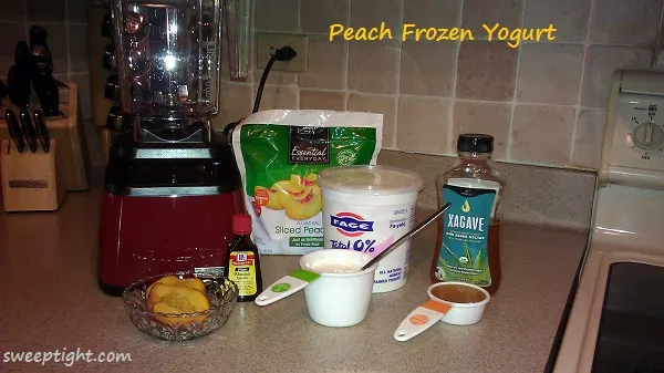 Ingredients to make peach frozen yogurt in a blender. 