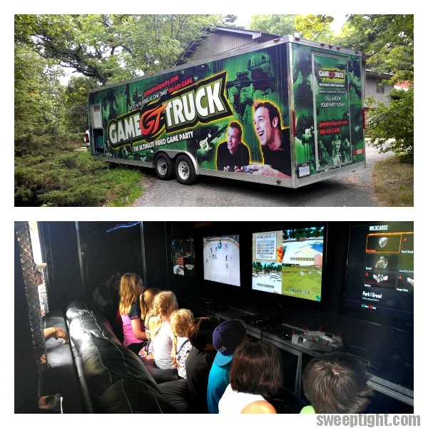 The Game Truck on the driveway and kids inside playing video games. 