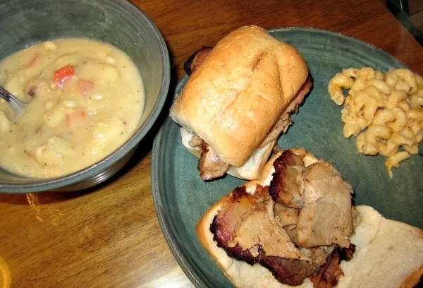 Soup, sandwiches, and mac and cheese on a plate. 