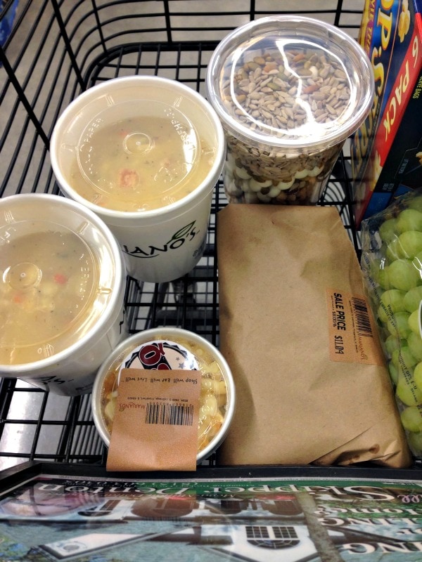 Soup and snacks in a grocery cart. 