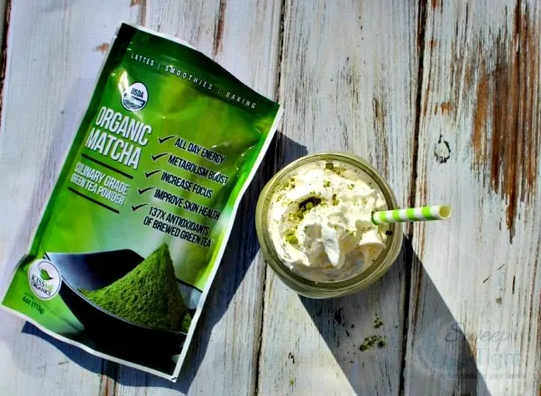 Overhead shot of Green Tea Frappuccino with a bag of matcha powder.