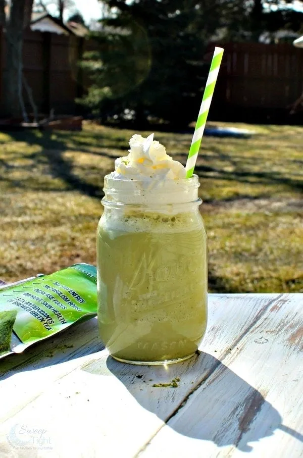 Starbucks copycat green tea frappuccino outside topped with whipped cream.