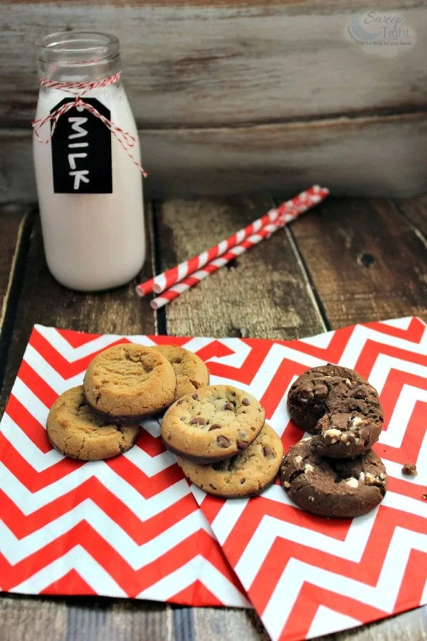 Mrs. Fields Nibblers® Cookies next to milk and straws. 