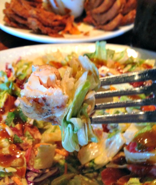 Fork full of Moonshine BBQ Chopped Salad from Outback. 
