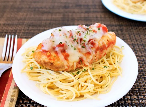 A plate of pasta and chicken Parmesan. 