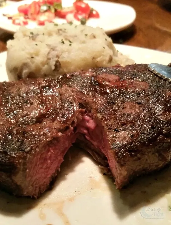 Steak cut open and a potato at Outback Steakhouse. 