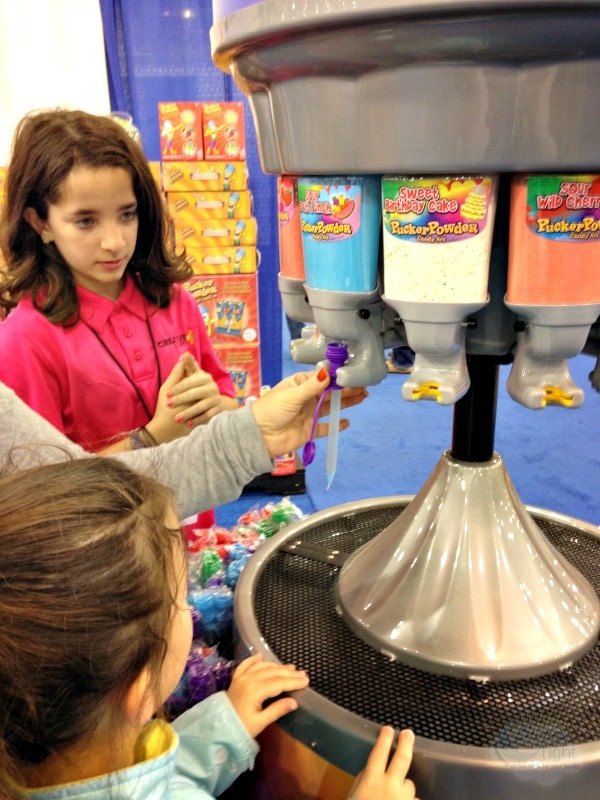 Filling up a candy tube with Pucker Powder. 