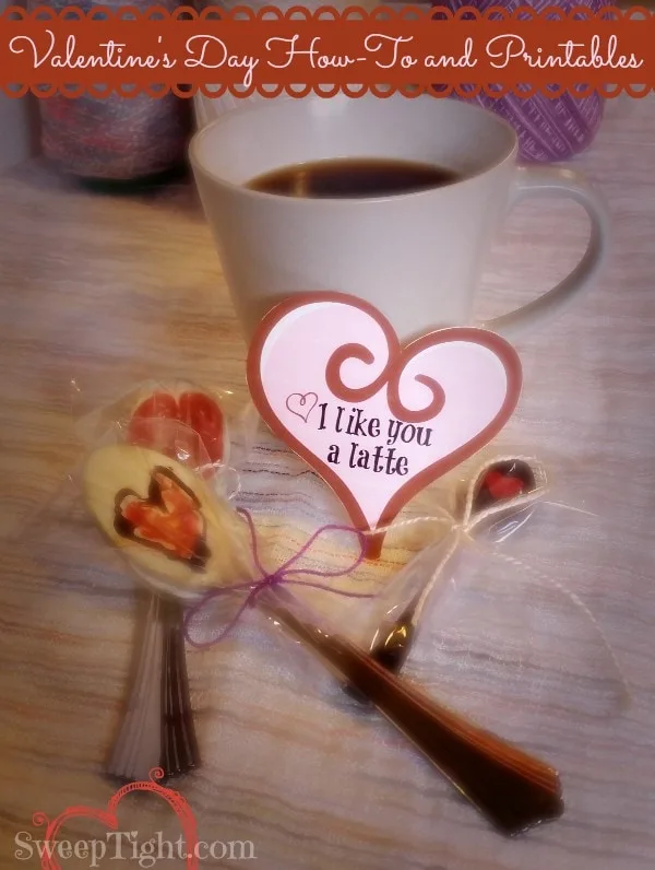 Chocolate dipped Valentine's Day spoons sitting by a cup of coffee.