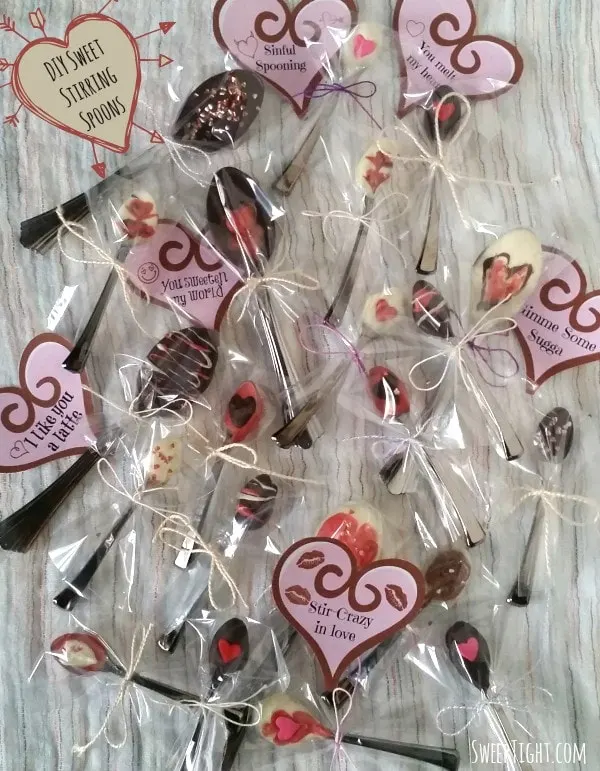 Several decorated stirring spoons with different tags for Valentine's day.