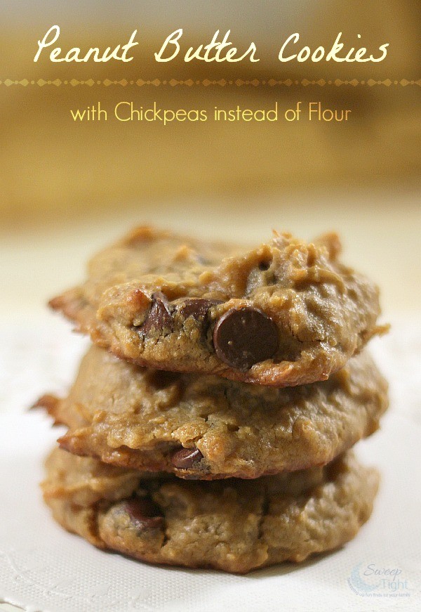 Three peanut butter cookies with chocolate chips stacked. 