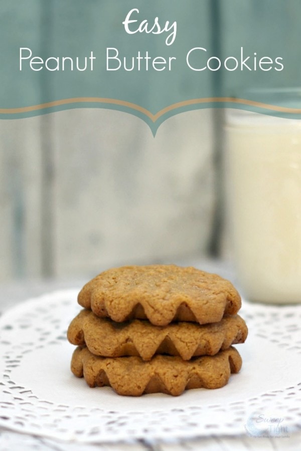 Three peanut butter cookies stacked on a doily. 