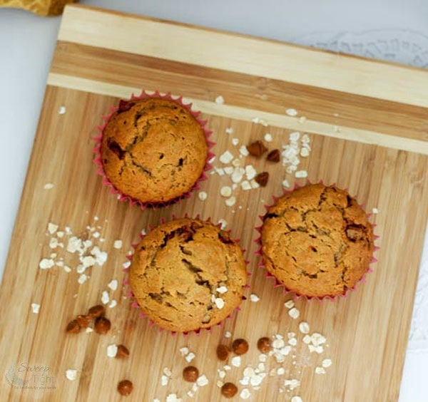 Muffins on a board with chips and oats. 