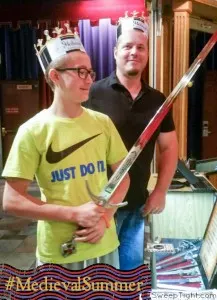 Adam and Uncle Mike looking at medieval swords at Medieval Times. 
