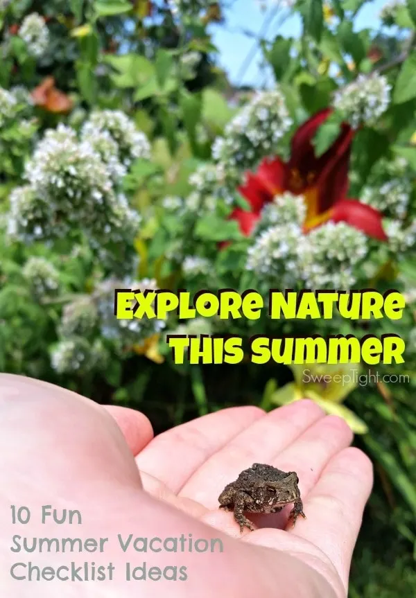 Holding a little frog by some flowers. 