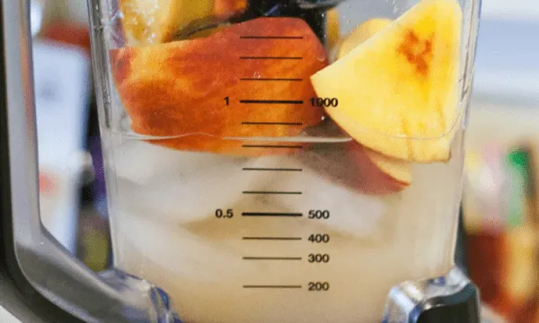 Peaches and ice in a blender