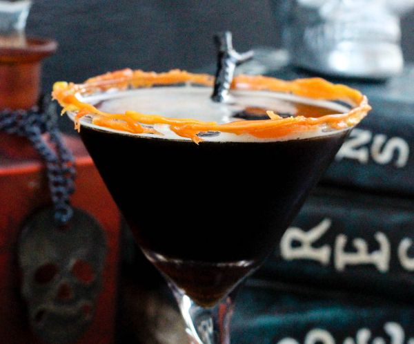 Coffee martini in a glass rimmed with candy corn. 