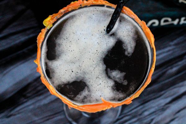 Above shot of coffee martini with a candy corn rim on the glass. 