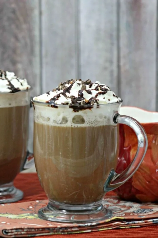 A clear glass of mocha cookie crumble cappuccino. 