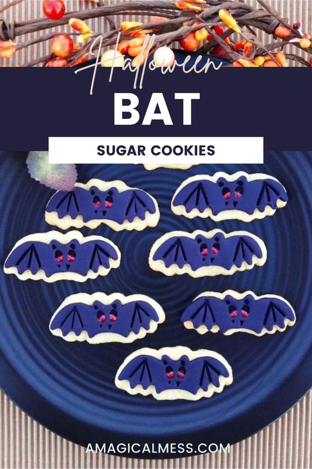 Sugar cookies in the shape of bats with red eyes on a blue plate with Halloween decor. 