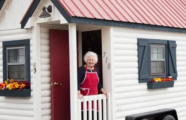 Nonna standing in the doorway of a tiny home. 