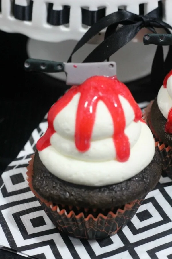 Chocolate cupcake with candy knife and red gel for Halloween. 