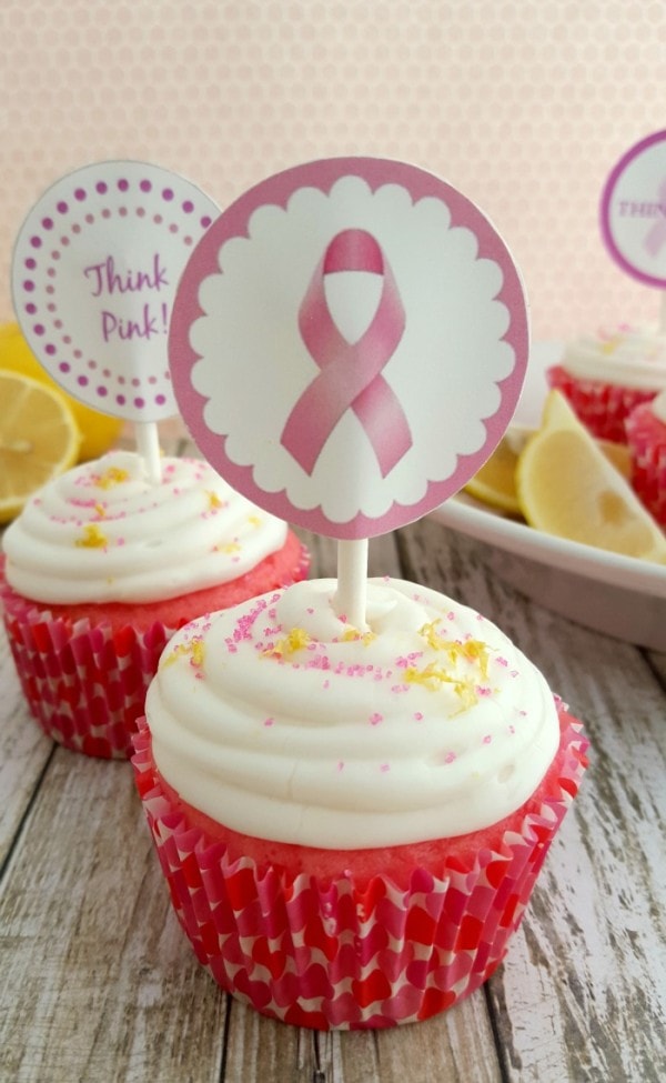 Strawberry pink cupcakes with breast cancer awareness toppers. 