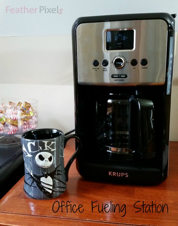 Krups Coffee Maker next to a mug. 