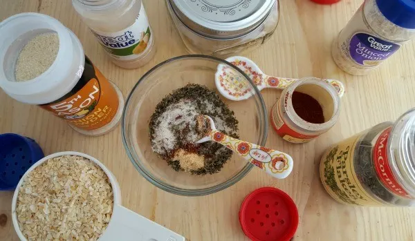 Mixing spices in a bowl for onion soup mix. 