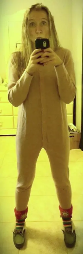 Person standing in a onesie taking a selfie. 