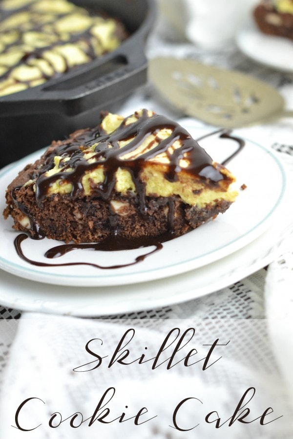 Chocolate skillet cake on a plate with a chocolate syrup drizzle. 