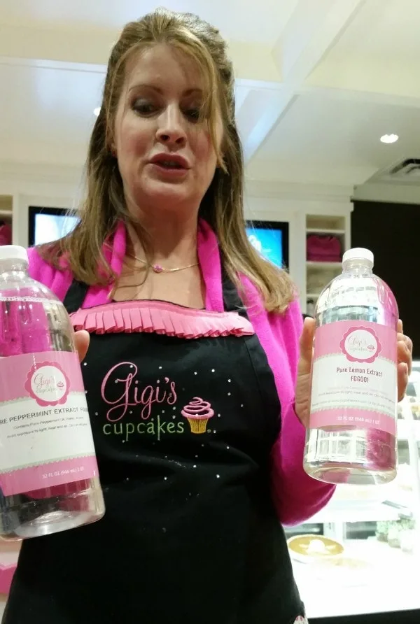 Gigi at Gigi's Cupcakes holding extracts they use. 