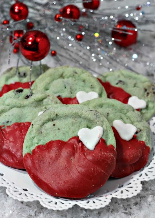 Mint chip Grinch cookies on a table next to Christmas decor. 