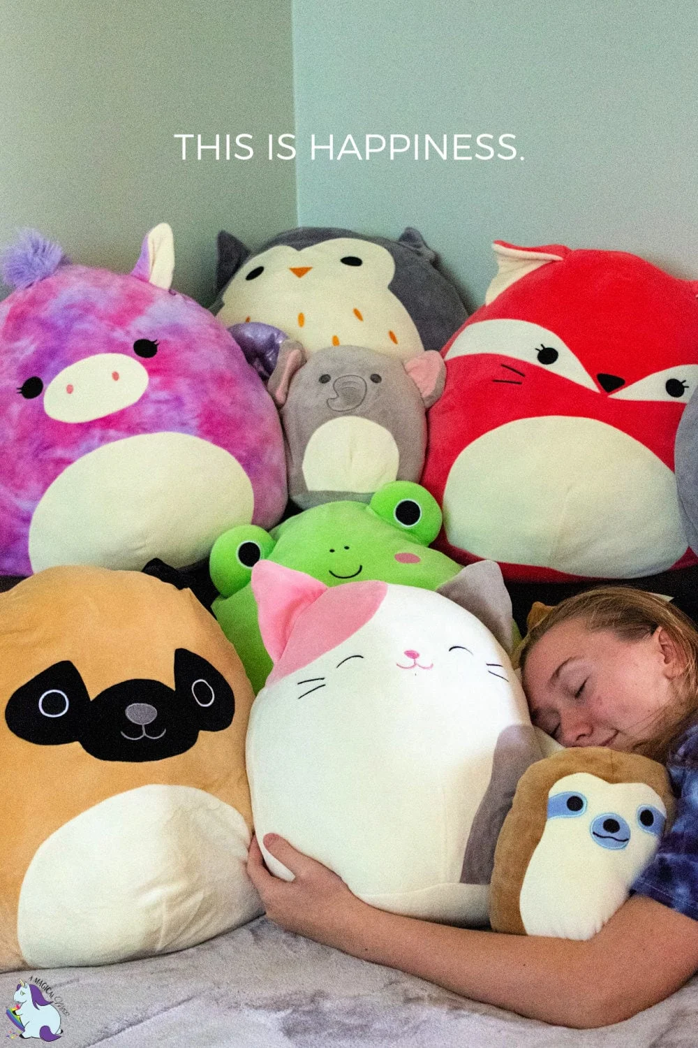 Teen girl hugging a stack of Squishmallows - These are the best gifts for EVERYONE!