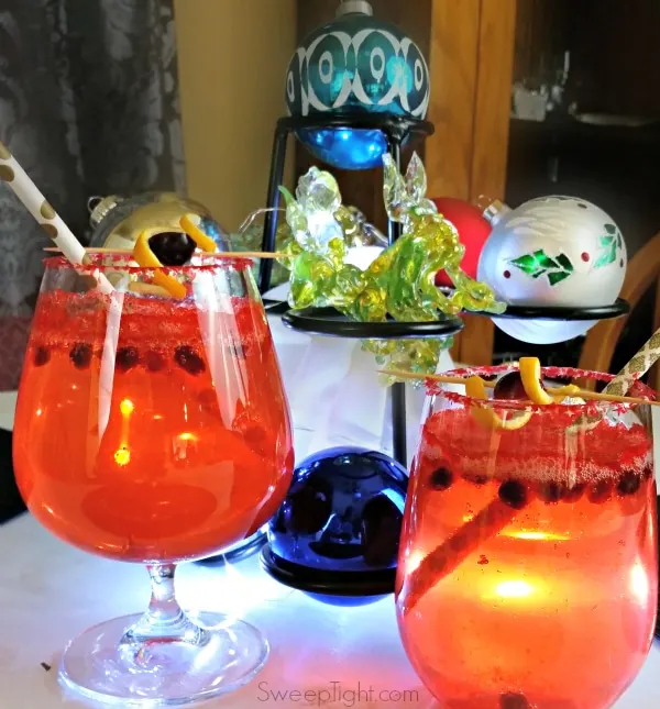 Red drinks on a table decorated for the holidays.