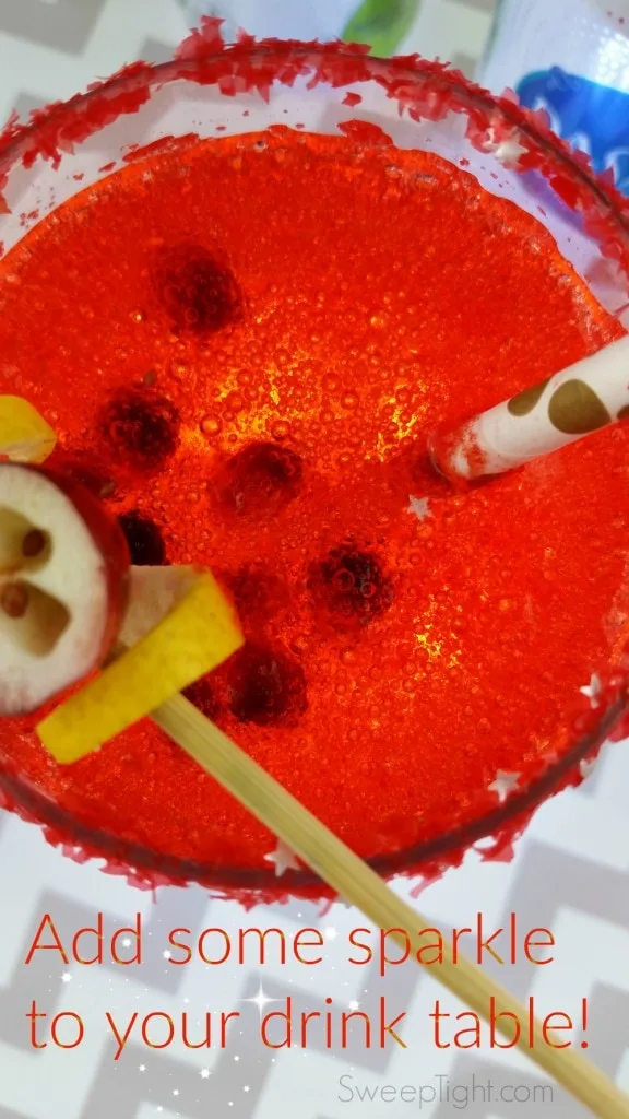 Overhead picture of sparkly drink with pomegranate seeds.