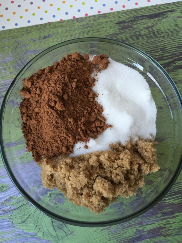 A bowl with cocoa powder, sugar, and brown sugar. 