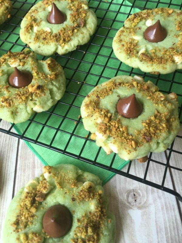 Green cookies with pistachios and chocolate kisses in the middle. 