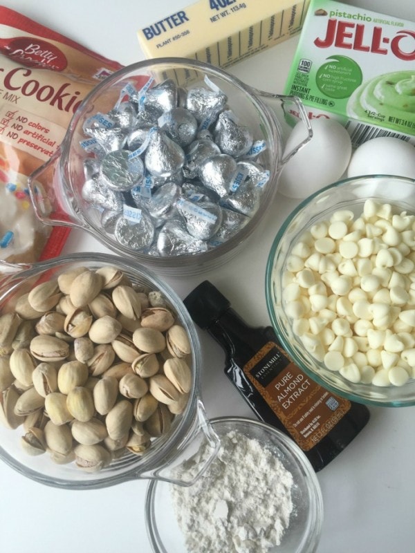 Cookie mix, butter, pistachio pudding, chocolate kisses, white chocolate chips, pistachios, and almond extract. 