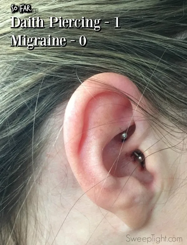 Pierced ear through the daith.