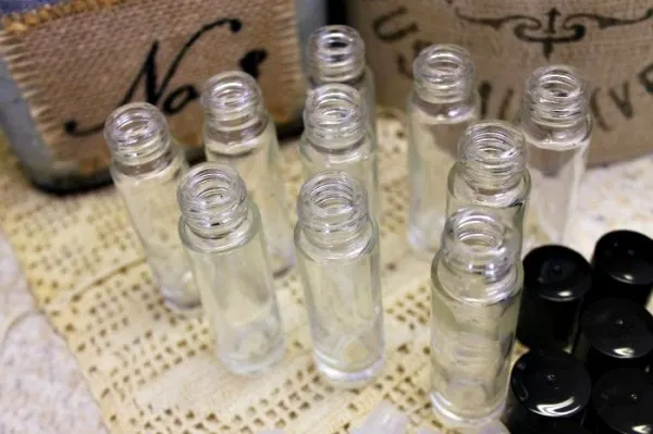 Clear, empty jars next to lids on a table. 