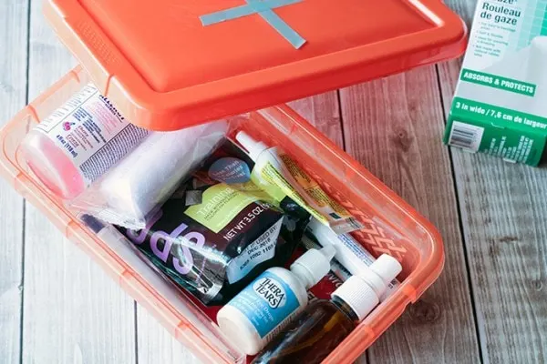 Red box with first aid items for pets. 