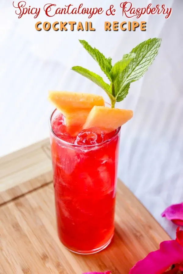 Red drink with cantaloupe slices.