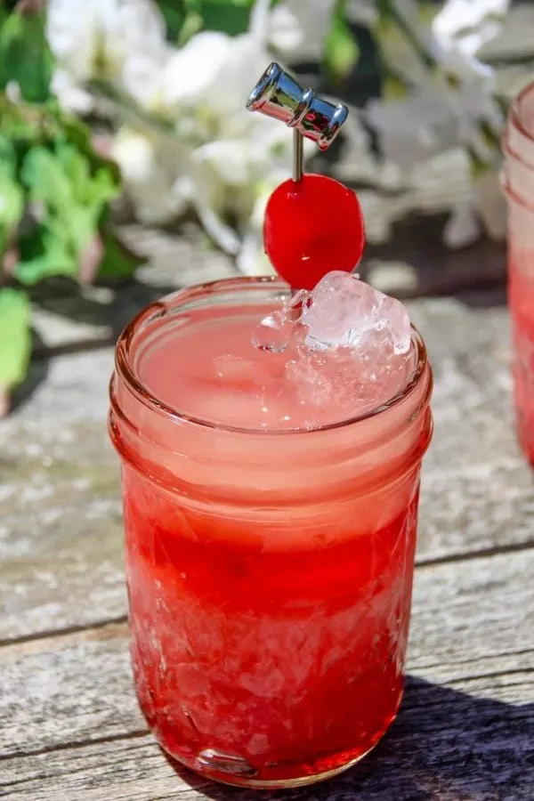 Bright red drink on a table outside. 