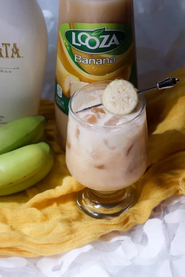 RumChata, banana nectar, bananas, and a cocktail on the table. 