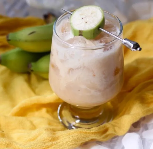 Banana RumChata cocktail in a glass with a sliced banana garnish. 