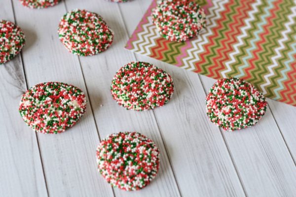 Little shortbread cookies covered in red and green sprinkles. 
